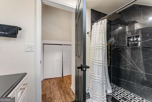 full bath with wood finished floors and a marble finish shower