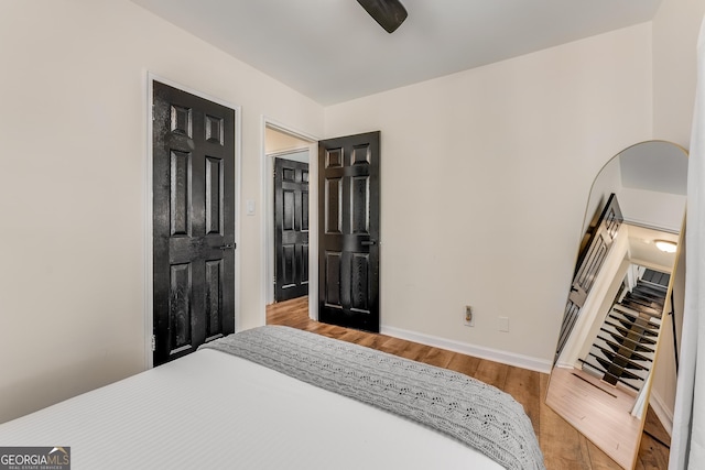 bedroom with wood finished floors and baseboards