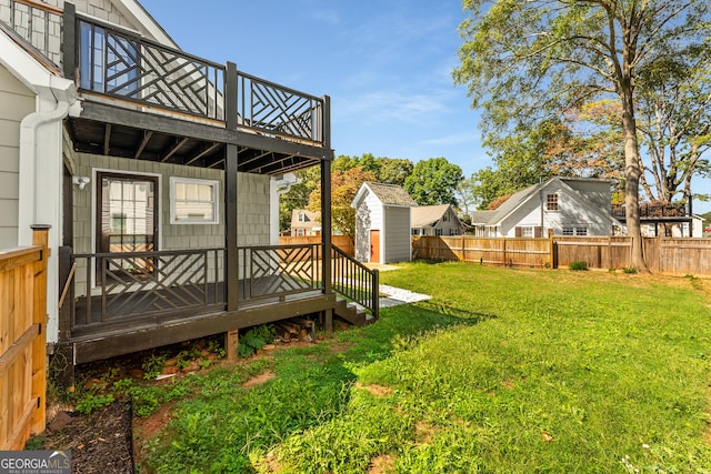 view of yard with a fenced backyard, an outbuilding, a deck, and a storage shed