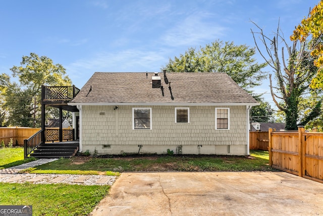 back of house with a patio, fence, a yard, a shingled roof, and crawl space