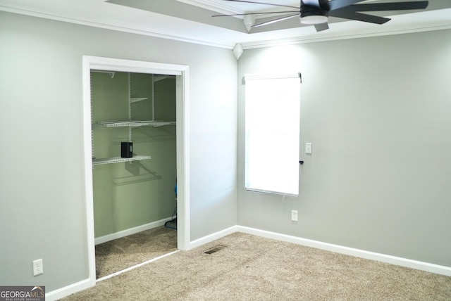 unfurnished bedroom with visible vents, baseboards, carpet, and crown molding