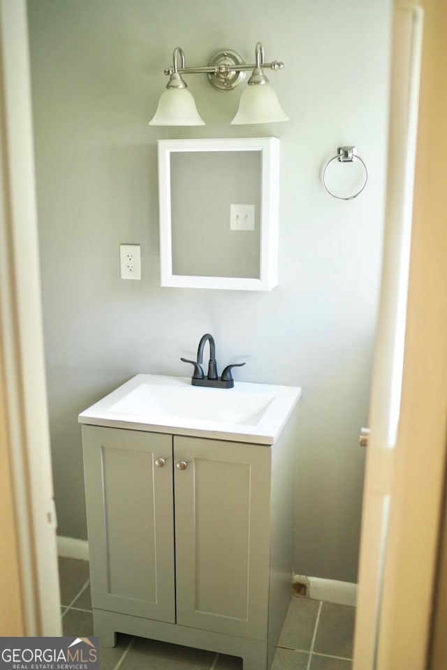 bathroom with vanity, tile patterned floors, and baseboards