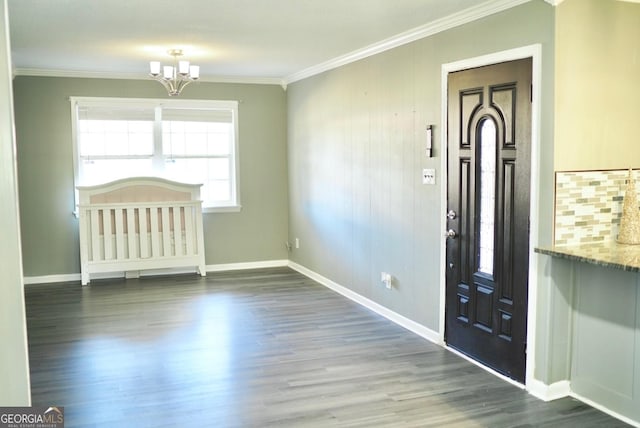 entryway with baseboards, an inviting chandelier, wood finished floors, and ornamental molding