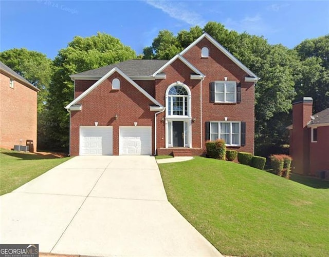 colonial-style house featuring brick siding, driveway, and a front yard