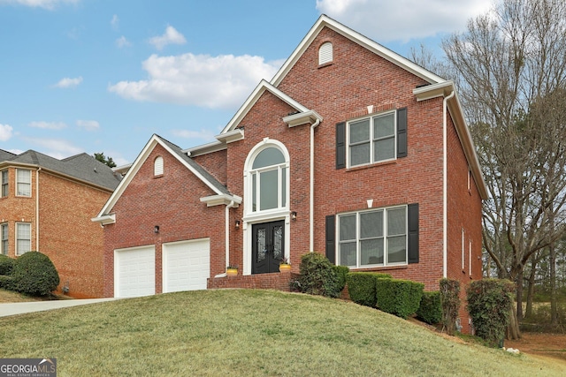 traditional-style house featuring french doors, driveway, brick siding, and a front lawn