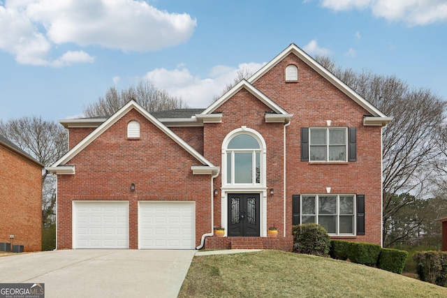 traditional home with driveway, a front lawn, french doors, a garage, and brick siding