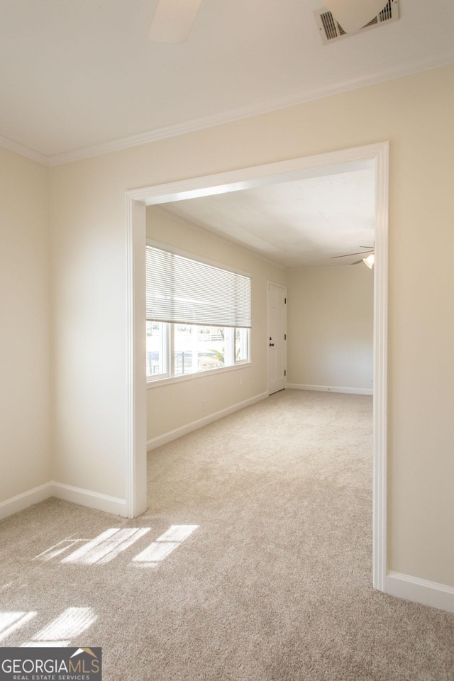 unfurnished room featuring a ceiling fan, carpet, and visible vents