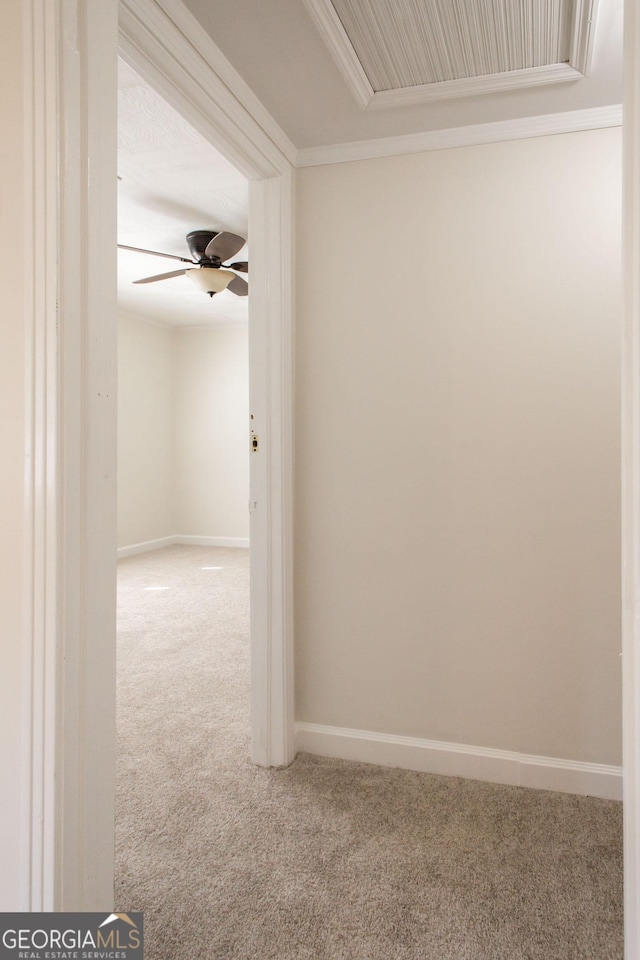 hall featuring baseboards, carpet floors, and ornamental molding