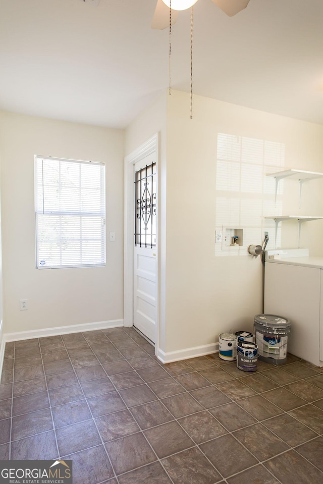 interior space featuring baseboards, hookup for a washing machine, and laundry area