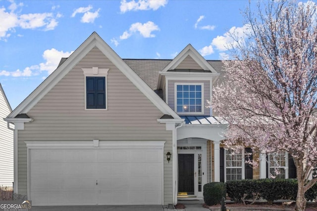 view of front of home featuring concrete driveway, a standing seam roof, and metal roof