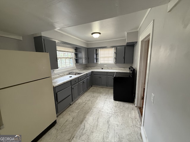 kitchen with a sink, gray cabinets, freestanding refrigerator, electric range, and open shelves