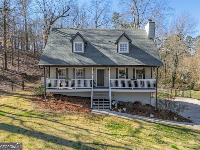 view of front of home featuring fence, covered porch, a shingled roof, stairs, and a front lawn