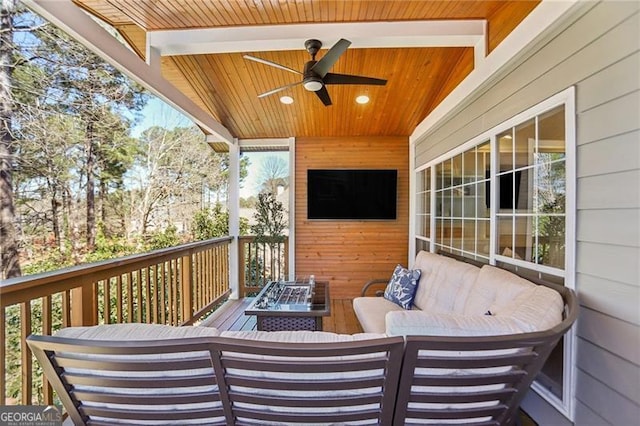 deck with outdoor lounge area and ceiling fan