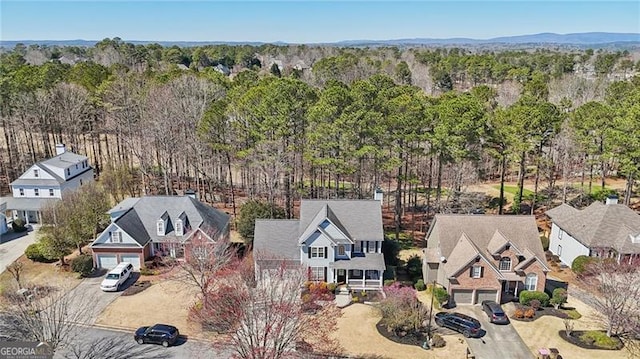 birds eye view of property featuring a residential view and a view of trees