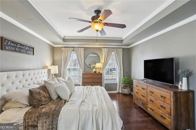 bedroom with a raised ceiling, dark wood-type flooring, and crown molding