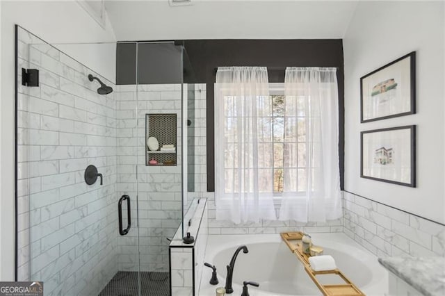 bathroom with a garden tub and a stall shower