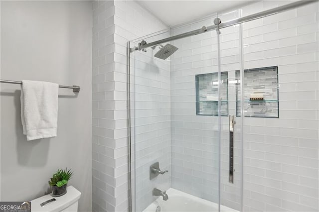 bathroom with toilet and enclosed tub / shower combo