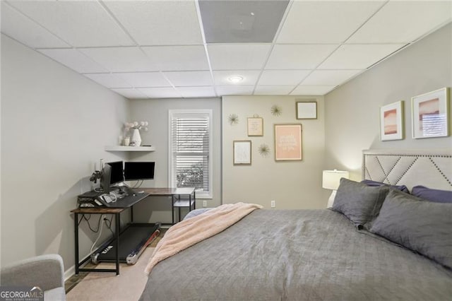 carpeted bedroom with a drop ceiling