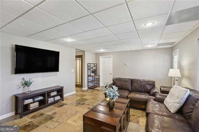 living room featuring recessed lighting, a paneled ceiling, and baseboards