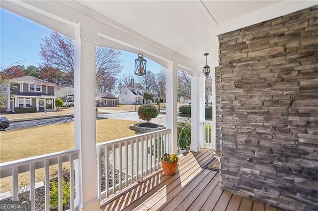 wooden deck with a porch and a residential view