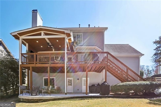 back of house with a ceiling fan, stairs, a wooden deck, a chimney, and a patio area