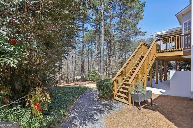 view of yard featuring stairway and a wooden deck