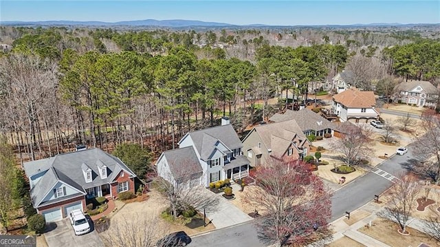 drone / aerial view featuring a forest view and a residential view