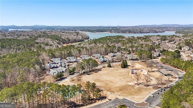 aerial view featuring a forest view and a water view