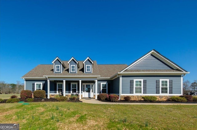 view of front facade with a front yard and stone siding