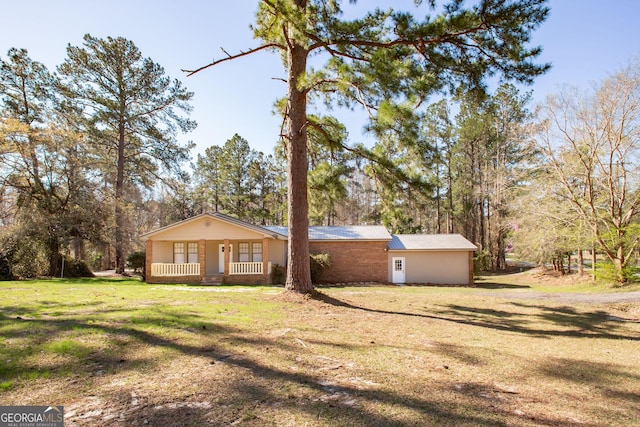 view of front of property with metal roof, a porch, and a front yard