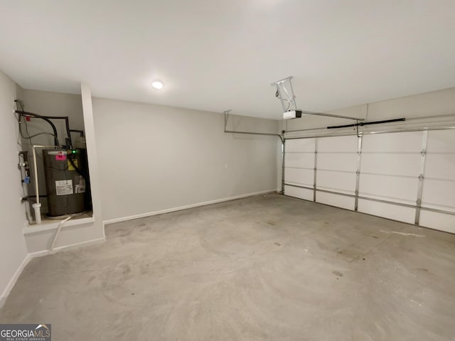 garage featuring a garage door opener, water heater, and baseboards