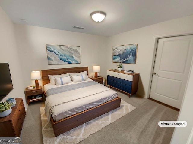 bedroom with visible vents and carpet flooring