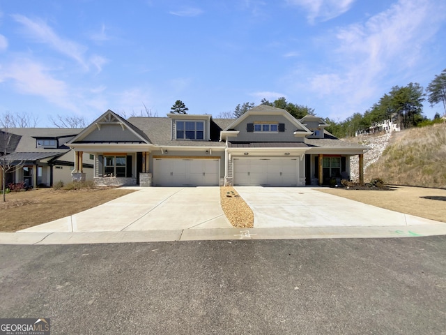 view of front of property featuring stone siding and driveway