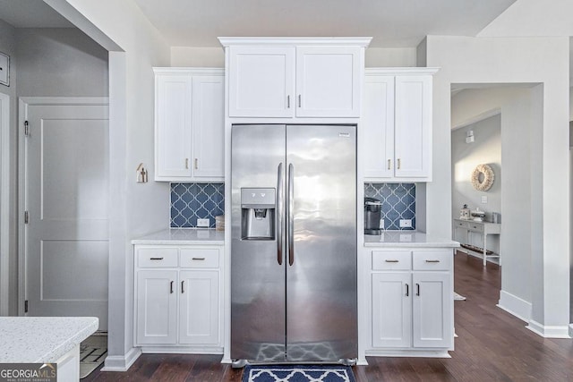 kitchen featuring stainless steel refrigerator with ice dispenser, tasteful backsplash, white cabinets, baseboards, and dark wood-style flooring