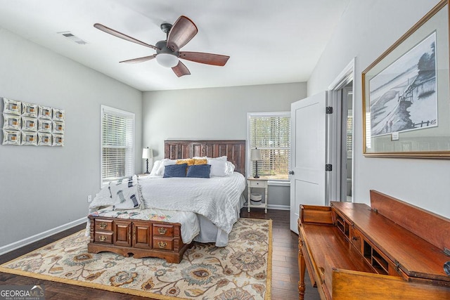 bedroom with visible vents, ceiling fan, dark wood-type flooring, and baseboards