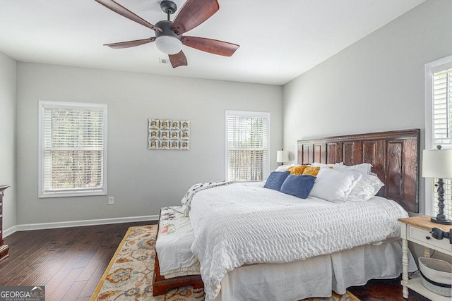 bedroom with ceiling fan, baseboards, and wood finished floors