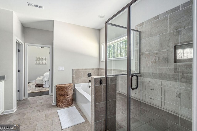 bathroom featuring a garden tub, visible vents, a shower stall, and connected bathroom