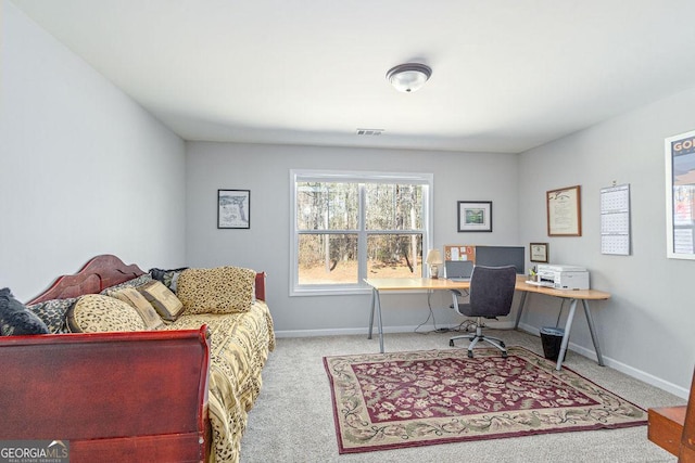 carpeted home office featuring visible vents and baseboards