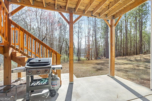 view of patio with area for grilling and stairs