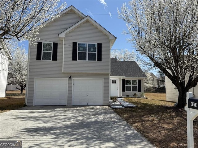 traditional home with an attached garage and driveway