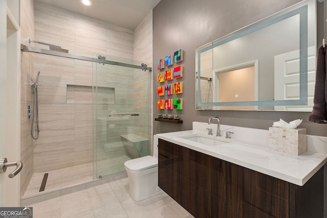 bathroom with vanity, a shower stall, toilet, and tile patterned floors