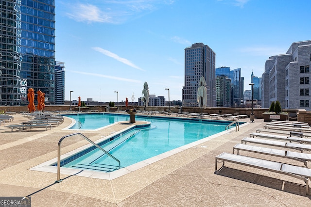 community pool featuring a patio and a city view