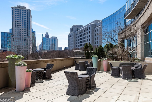 view of patio / terrace with outdoor dining area and a view of city