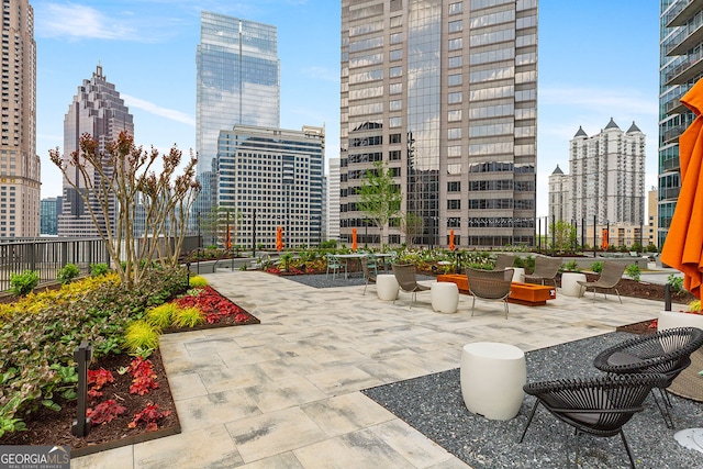 view of patio / terrace featuring a city view and fence