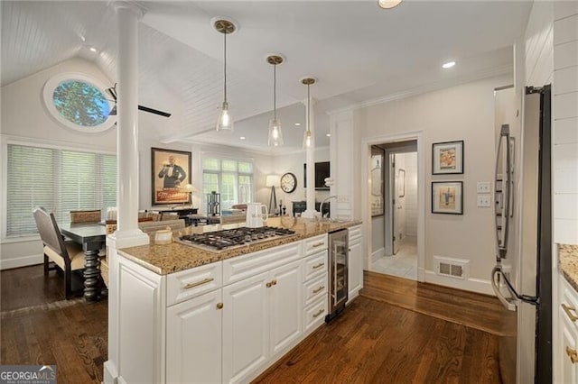 kitchen with beverage cooler, visible vents, dark wood finished floors, appliances with stainless steel finishes, and white cabinetry
