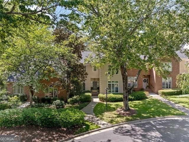 view of front of house with a front lawn and stucco siding