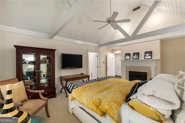 bedroom with visible vents, lofted ceiling with beams, a fireplace, ceiling fan, and light carpet