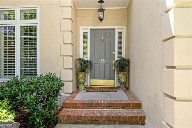 doorway to property featuring stucco siding