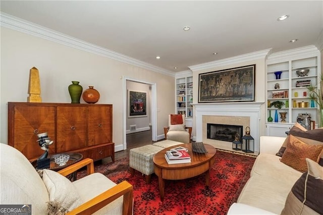 living area with recessed lighting, built in shelves, ornamental molding, and a fireplace