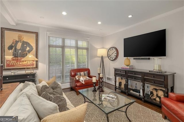 living room with visible vents, crown molding, and wood finished floors